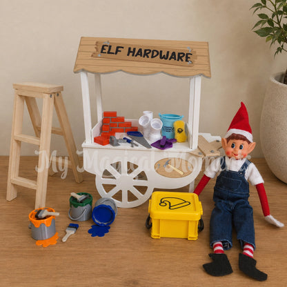 Elf wearing overalls, selling various tools and items at a hard ware store front. ladder, bricks, plumbing pipes bucket and sponge, tools, wood pieces, paint and a storage container