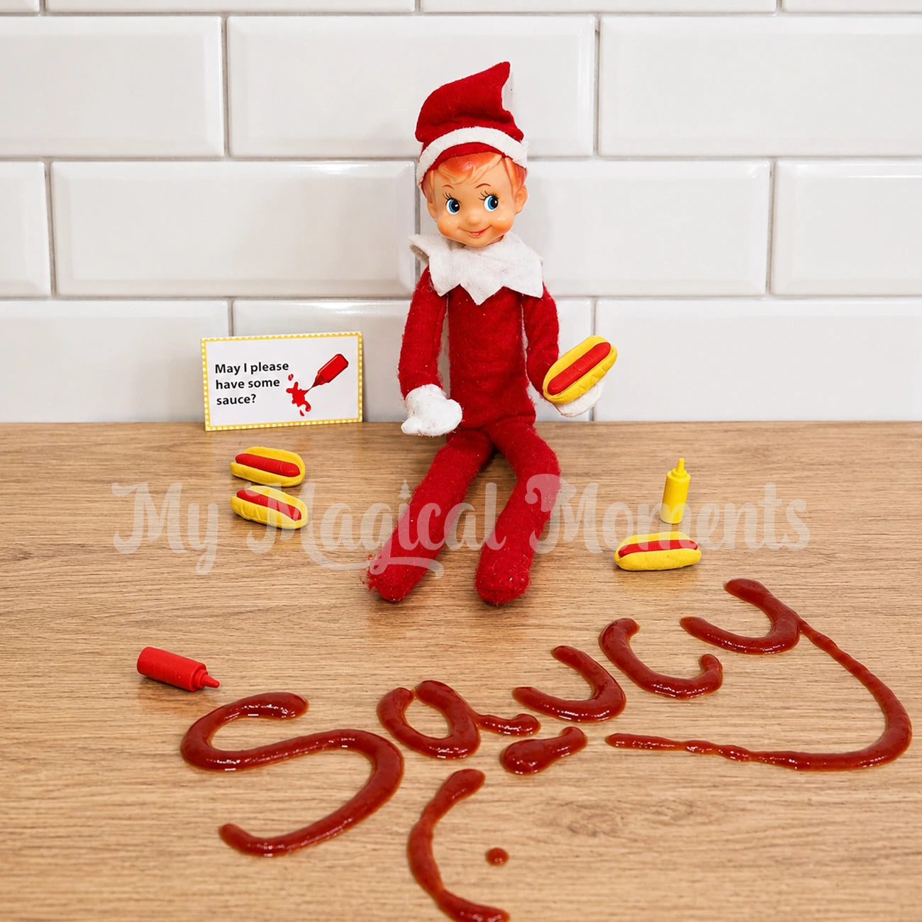 Elf holding, mini hot dog props with mini tomato sauce, mustard and the words Saucy spelt out with ketchup