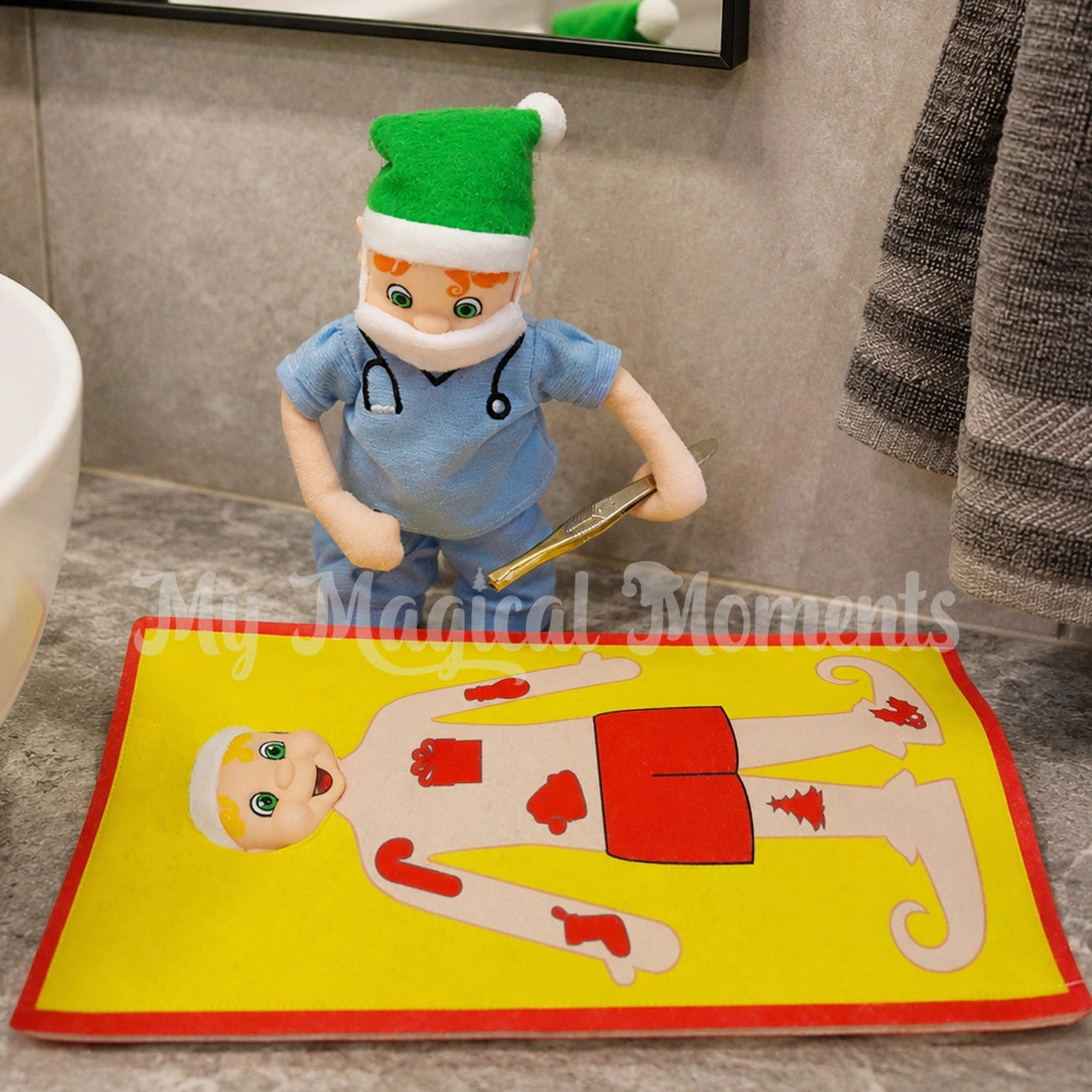 Elf with orange hair wearing a mini face mask and nurse outfit, holding a pair of tweezers. Second elf is wearing an elf operation outfit