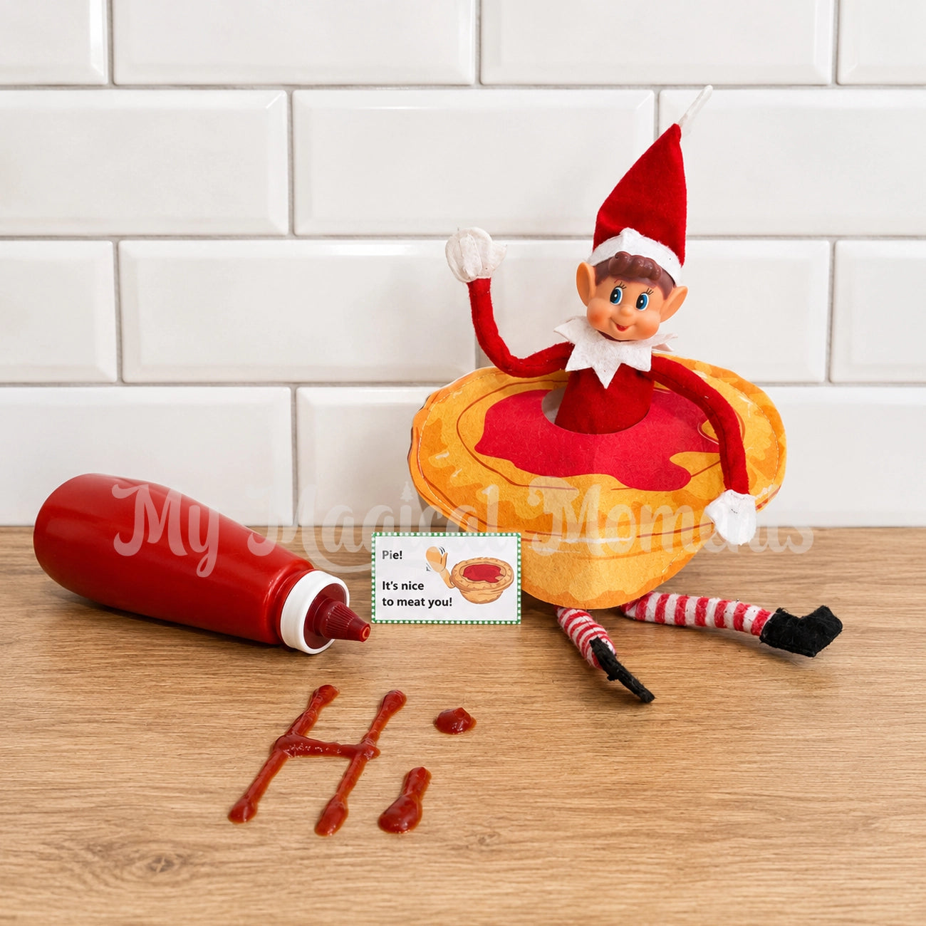 Elf wearing a Pie Costume, with the words Hi written in tomato sauce 