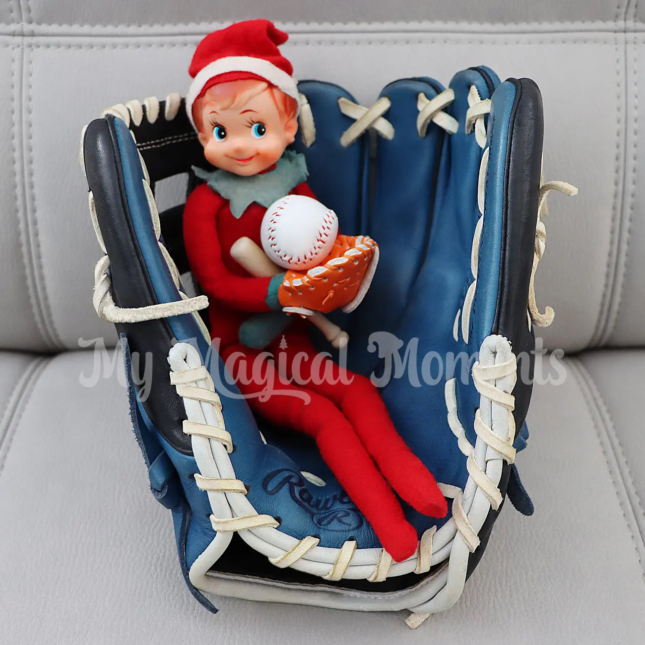 Elf sitting in a baseball glove with miniature baseball props