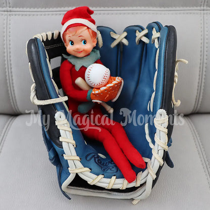 Elf sitting in a baseball glove with miniature baseball props