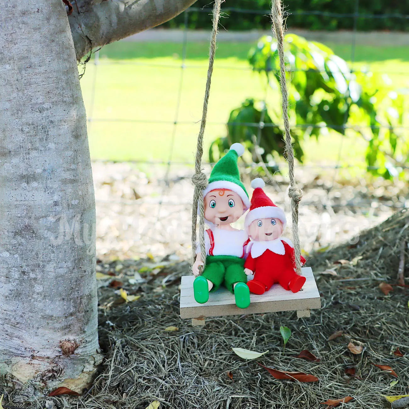 Elf baby and toddler on a miniature wooden elf swing