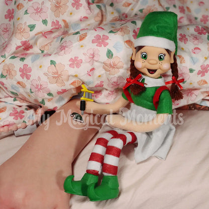 My Elf Friends Tattooing child sleeping with a temporary Christmas tattoo