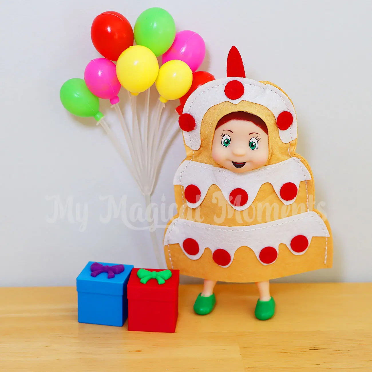 Elf toddler wearing a cake costume, celebrating a party