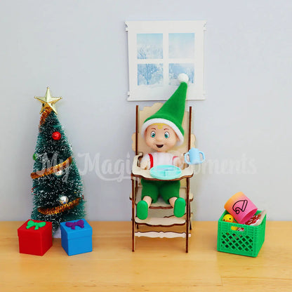 Elf toddler in high chair with sippy cup, plate and mini elf props