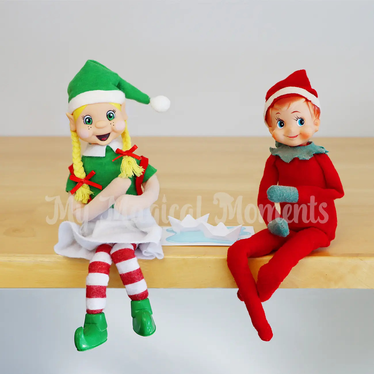 Elves having a boat race with mini paper boat props