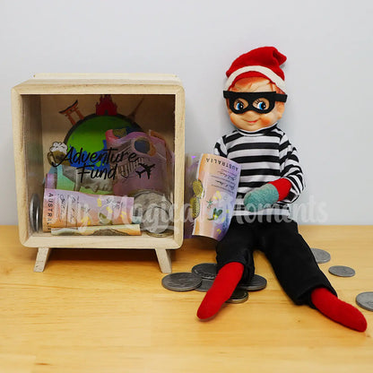 Elf dressed as a burglar stealing money from a money box