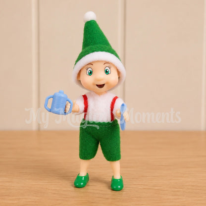 elf toddler holding a sippy cup and spoon