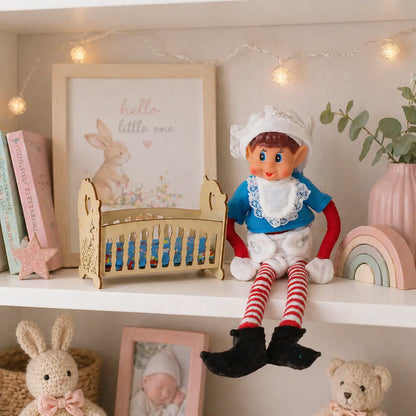 Elves behavin badly wearing a baby costume on a shelf with a cot in a bedroom