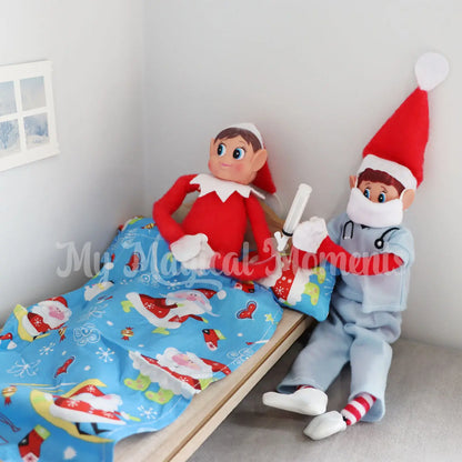 Elves behavin Badly in an elf bed with a feeding tube with one elf dressed as a nurse