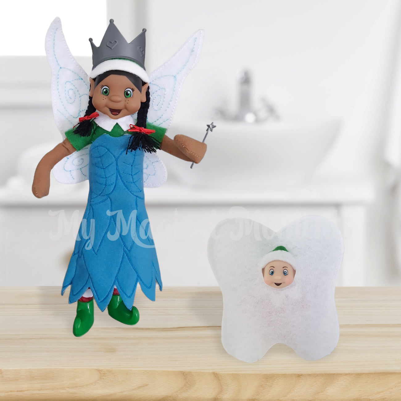 Black hair elf dressed as a fairy with a baby elf wearing a tooth costume