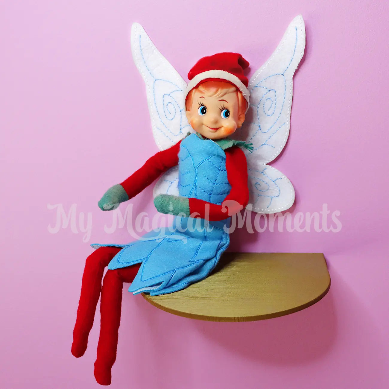 elf wearing a fairy costume on a shelf