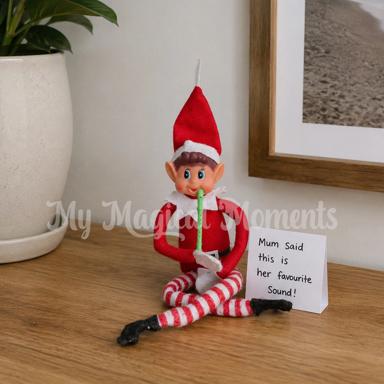 Elf sitting on a entry table, with a mini recorder prop with a note saying mum said this is her favourite sound