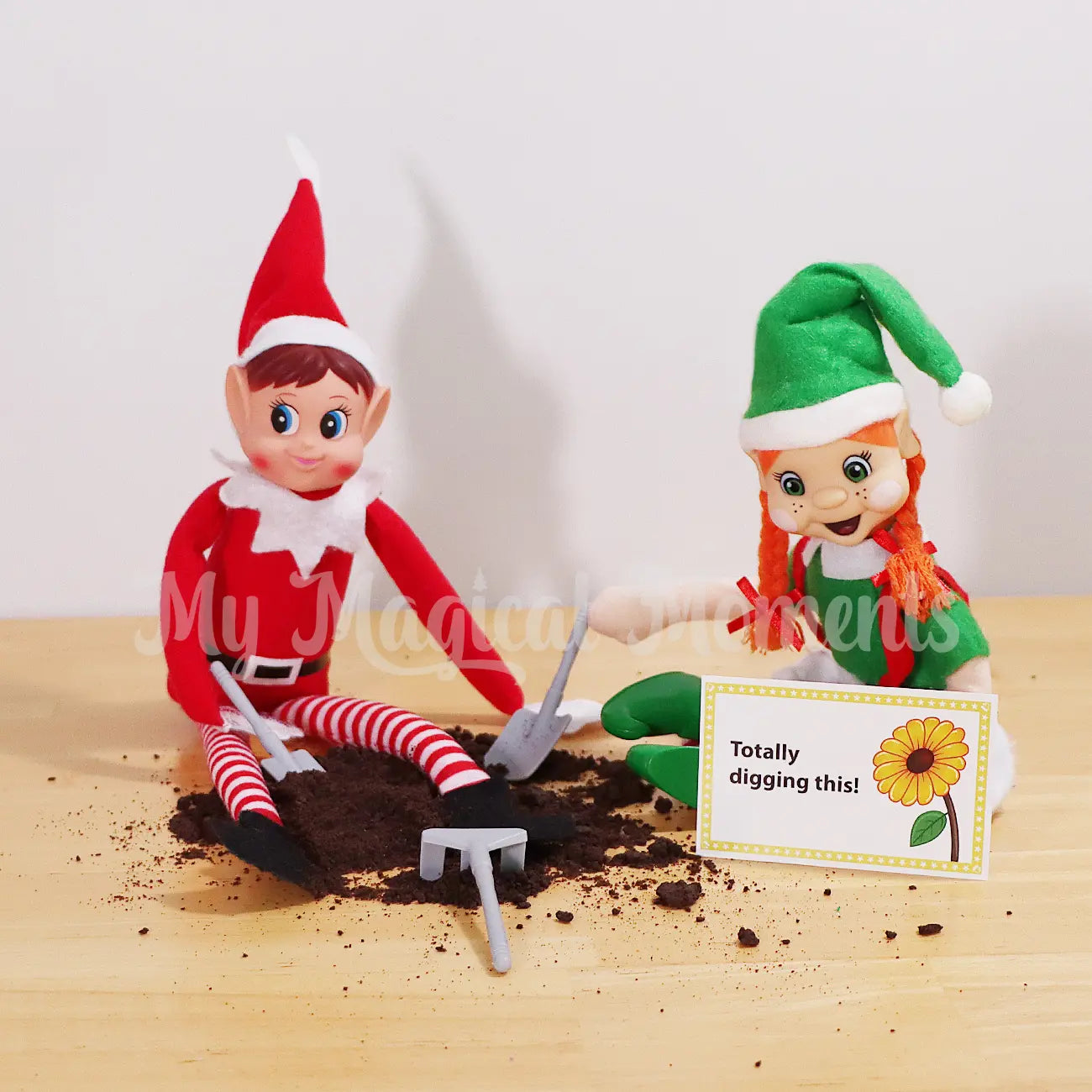 Two Elves digging in grounded up Oreos for dirt with mini gardening elf props