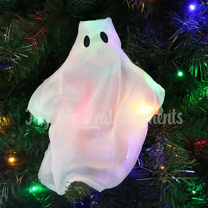 elf wearing a ghost costume in a Christmas tree