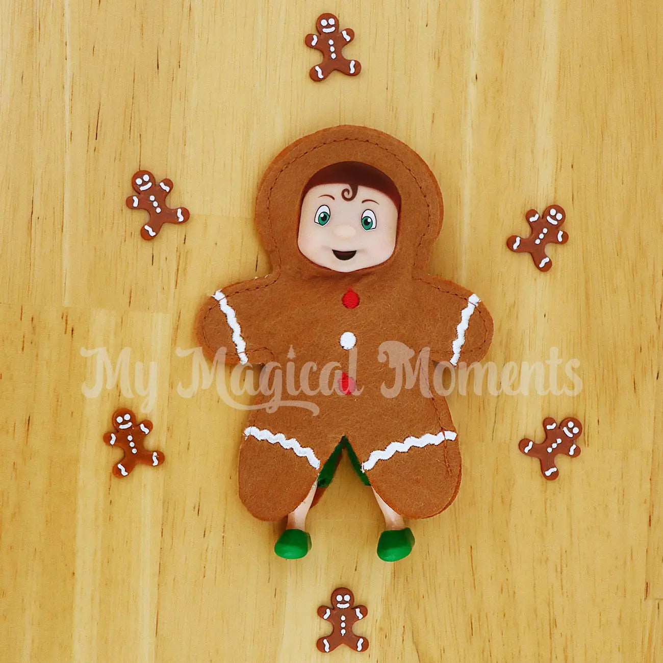 Elf toddler wearing a gingerbread costume, with mini gingerbread