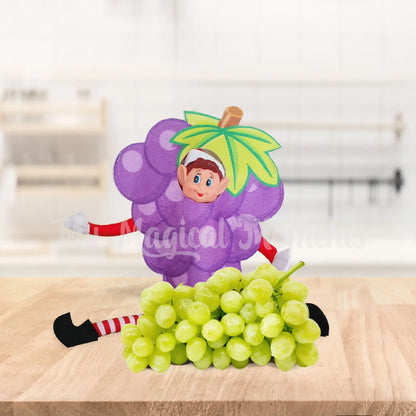 Elves behavin badly elf wearing a grape costume on a kitchen bench