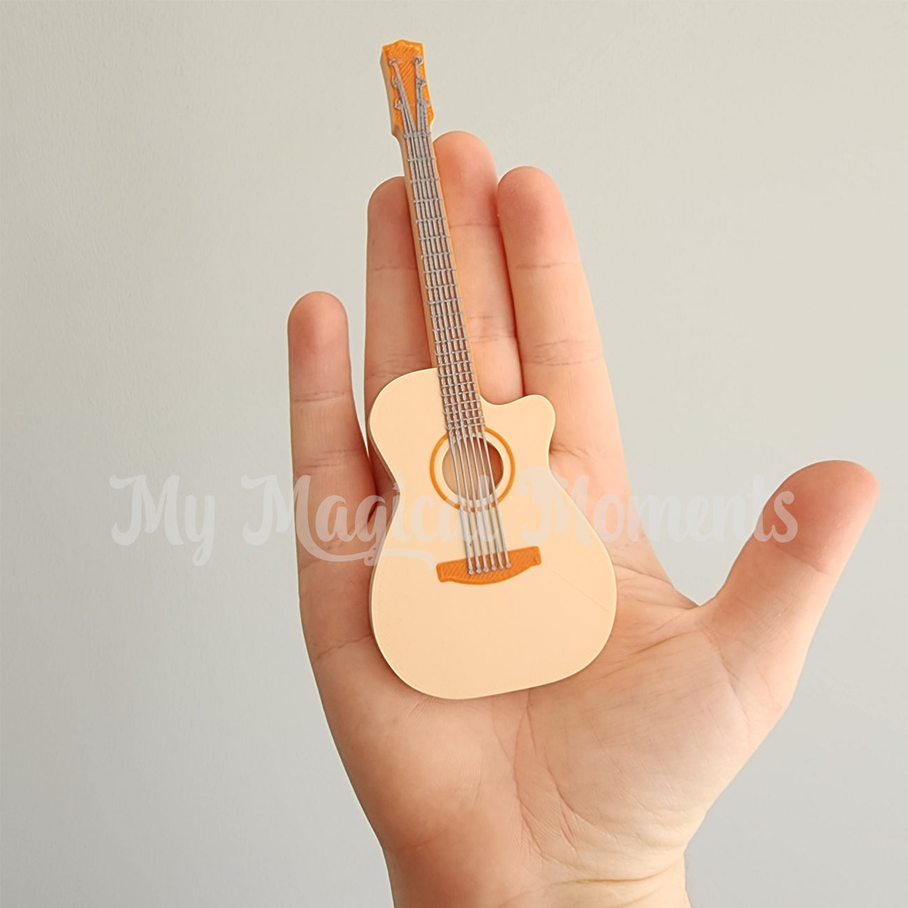 Miniature 3d printed guitar comparison to human hands