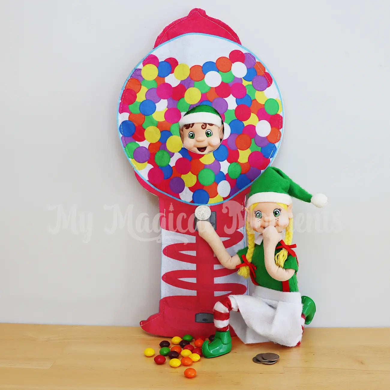 Elves buying candy from a elf dressed as a gumball machine