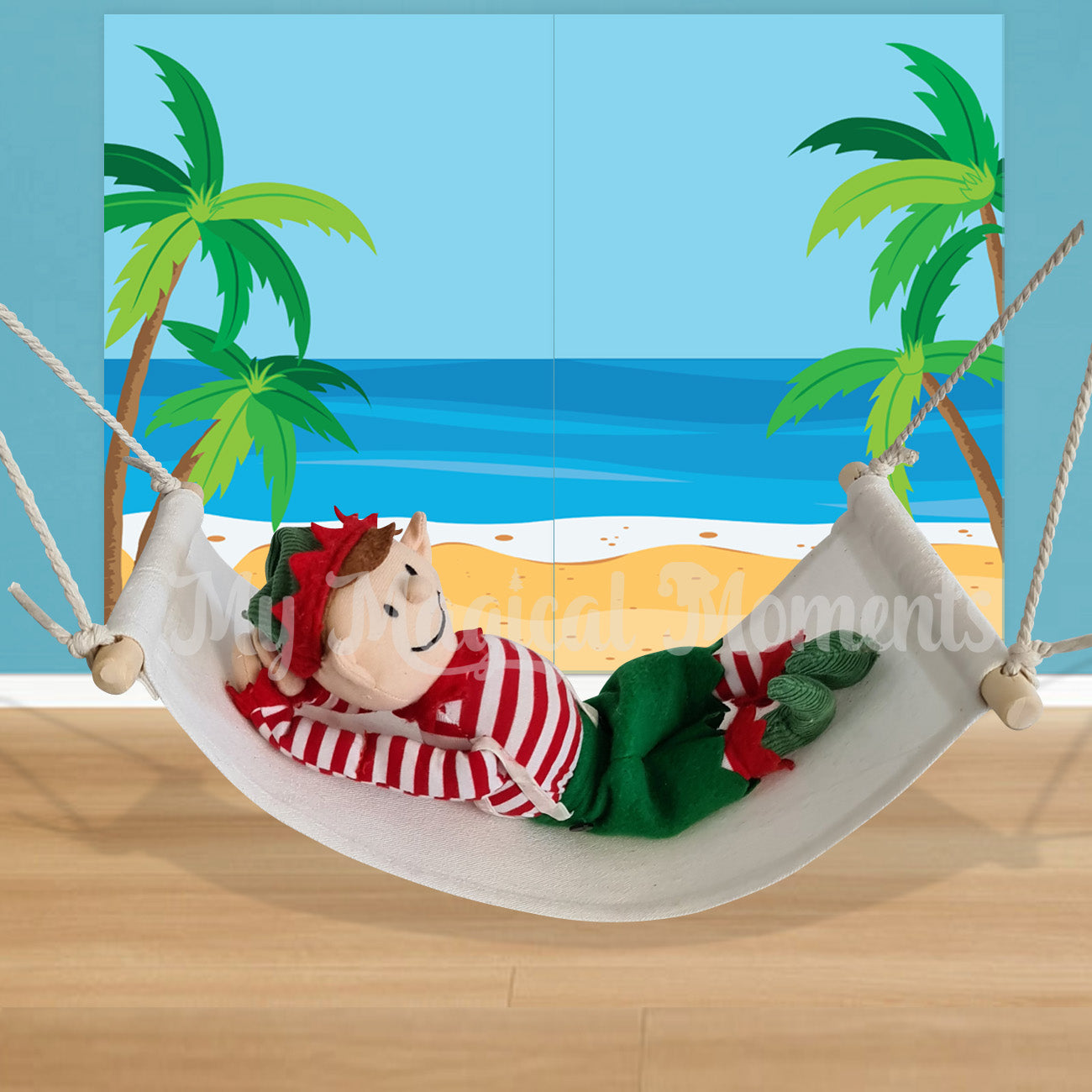 elf For Christmas chilling in a miniature hammock