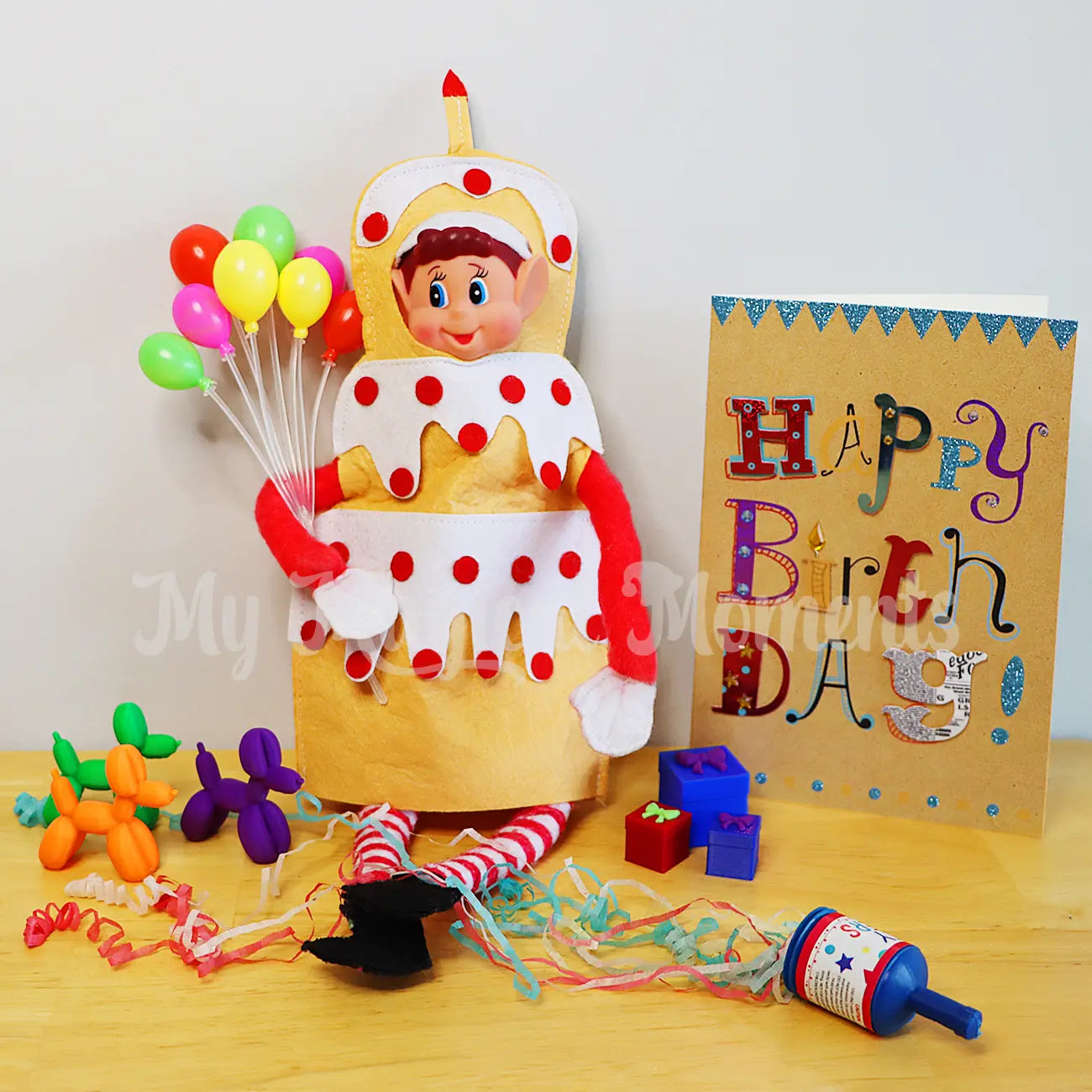 elf wearing a cake costume having a birthday party