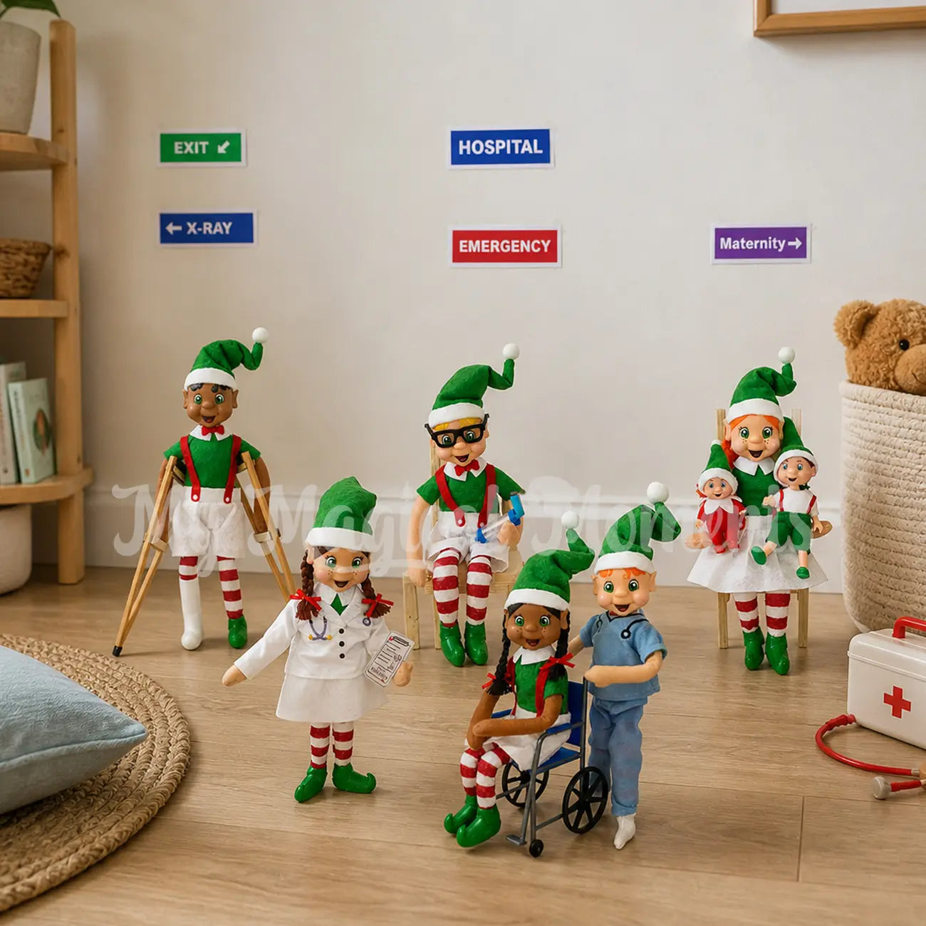 Elf Hospital Scene, with free printable hospital signs. Emergency, x-ray and maternity. One elf has a broken leg, another is having an asthma attack. A mum elf has her elf baby and elf toddler. A elf dressed as a nurse is pushing an elf in a blue wheelchair