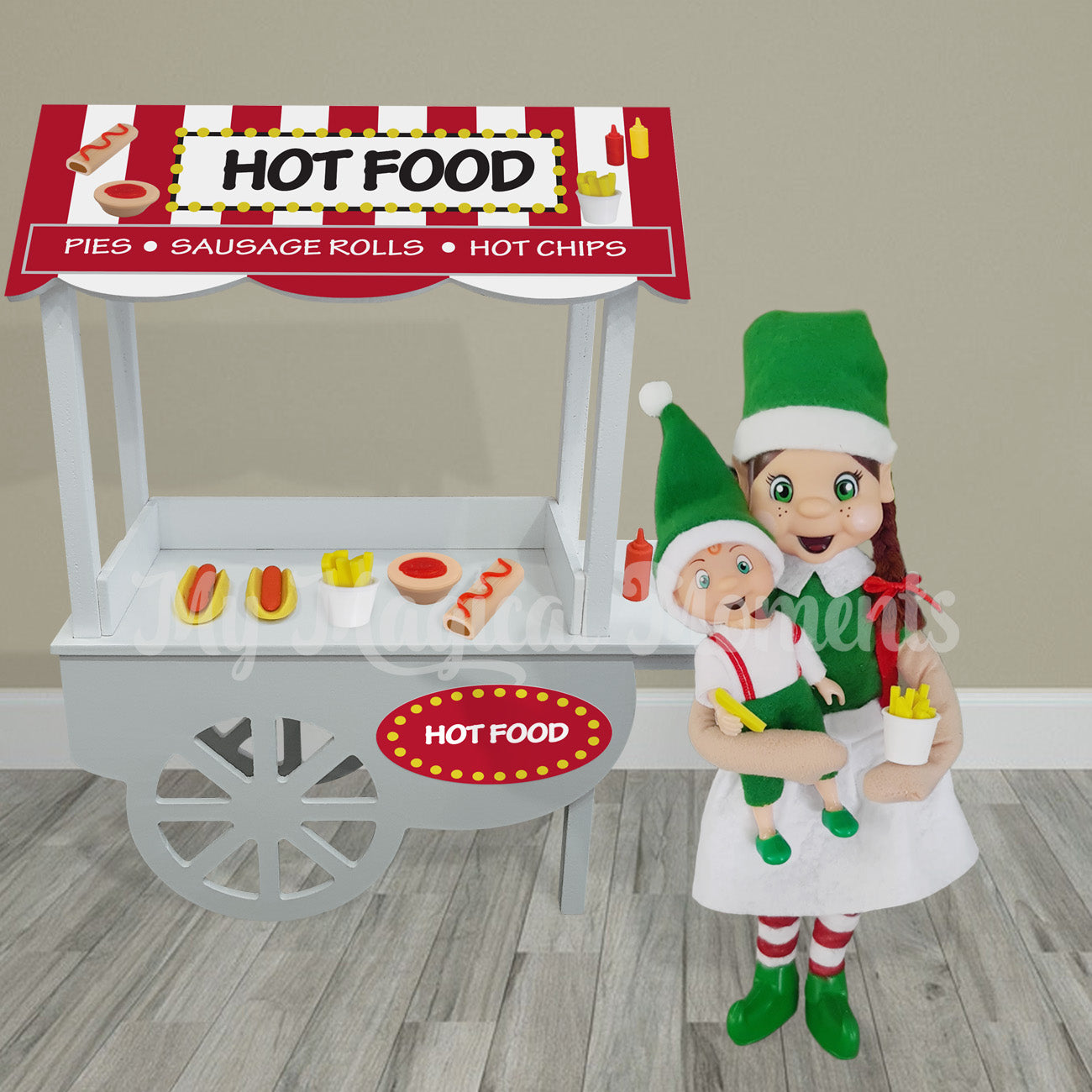 Mother elf holding toddler and chips in front of a hot food store