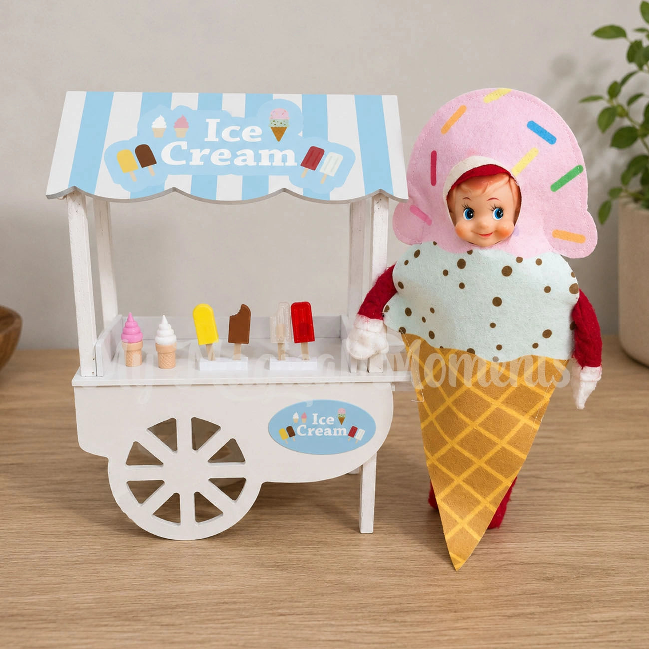 elf dressed as an ice cream cone selling ice cream from a shop with mini ice creams, soft serve