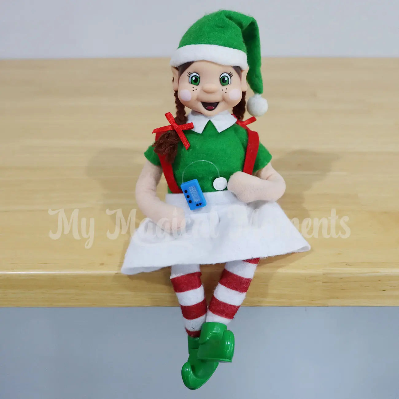 Elf Friends with a miniature insulin pump prop sitting on a table