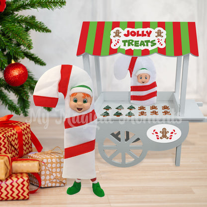 elf dressed as a candy cane selling gingerbread cookies