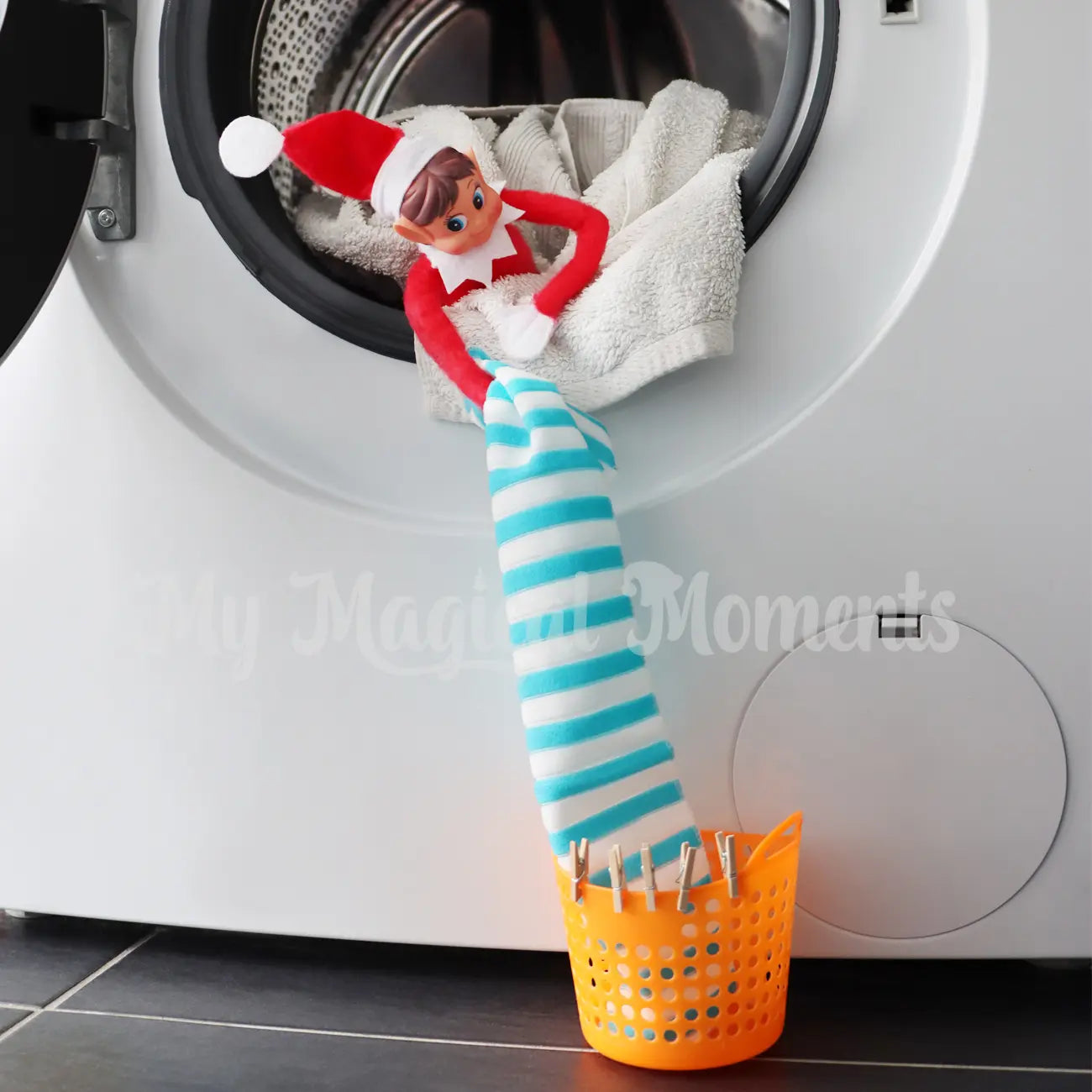 Elf doing the laundry in the washing machine with miniature washing basket