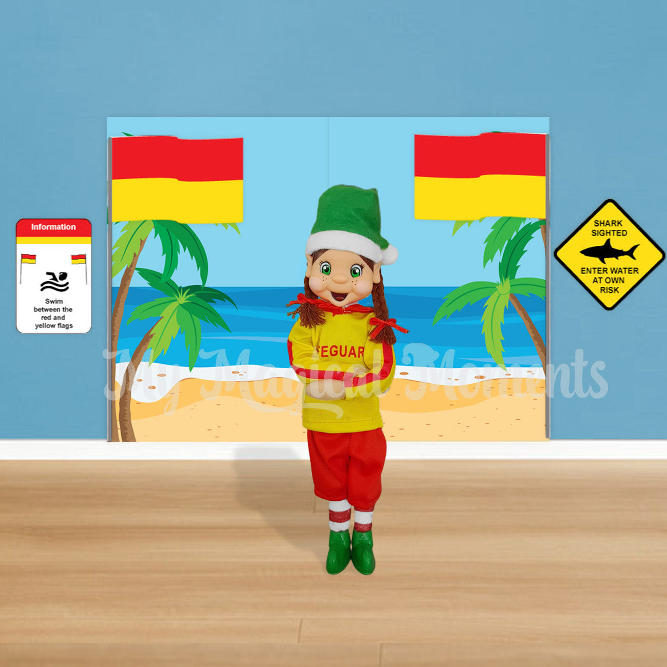 elf dressed as a lifeguard with a beach scene printable and swim between the flags signs.