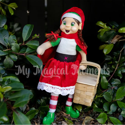 elf wearing a red riding outfit holding a mini picnic basket