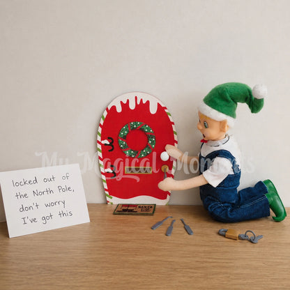 Elf wearing overalls picking a lock on an elf door with a mini elf locking pick. there is a sign that says locked out of the north Pole, don't worry I've got this