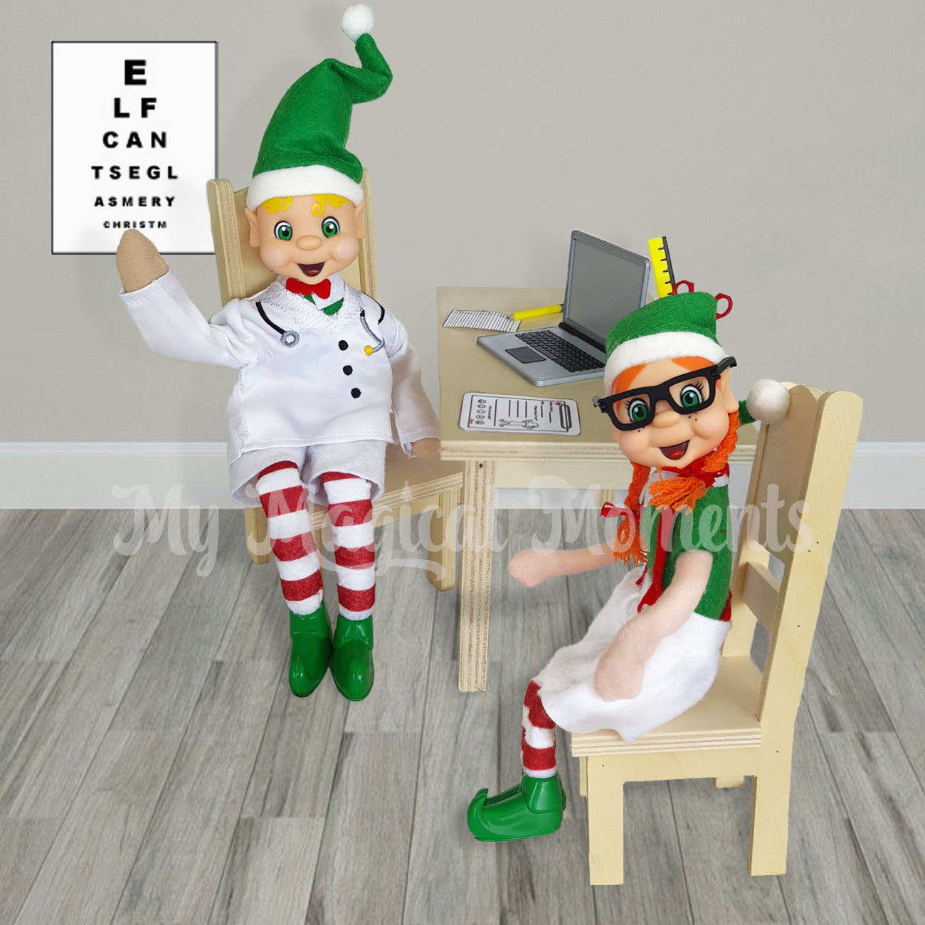 Elf Optometrist scene. Pointing to a printable eye chart. With a orange hair girl elf wearing glasses. There is a wooden desk with a miniature laptop and clipboard.