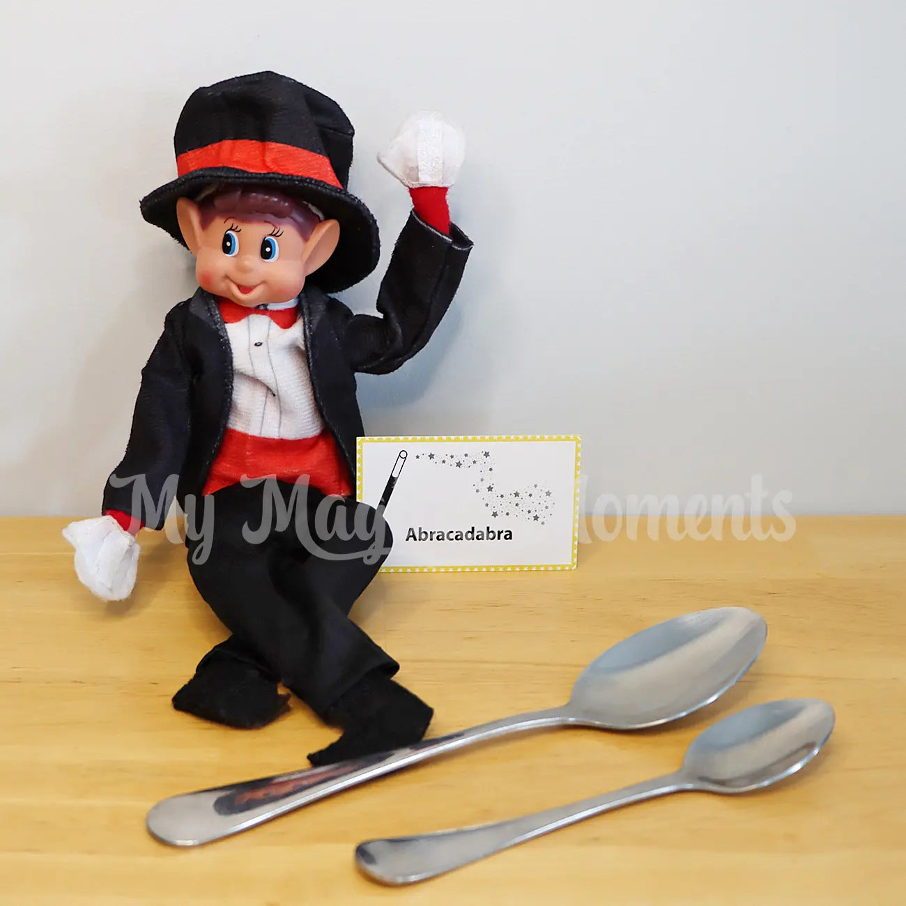 Elf wearing a magician outfit doing a magic trick with spoons