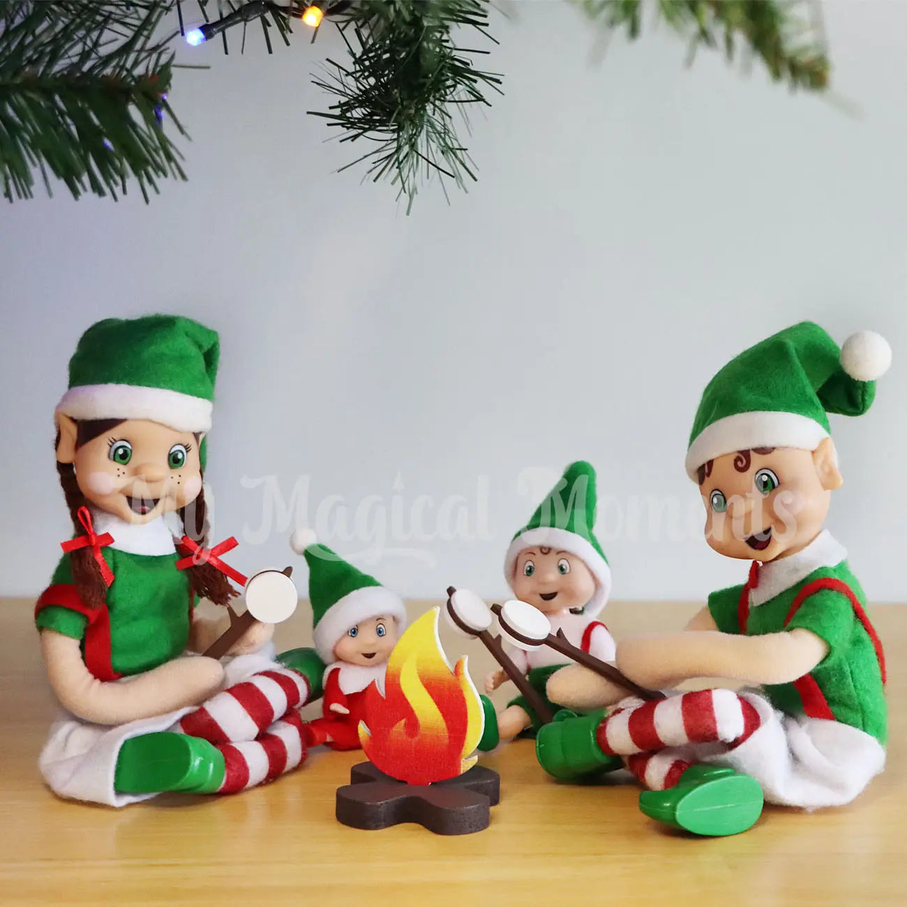 A Family of elves toasting marshmallows under the Christmas Tree