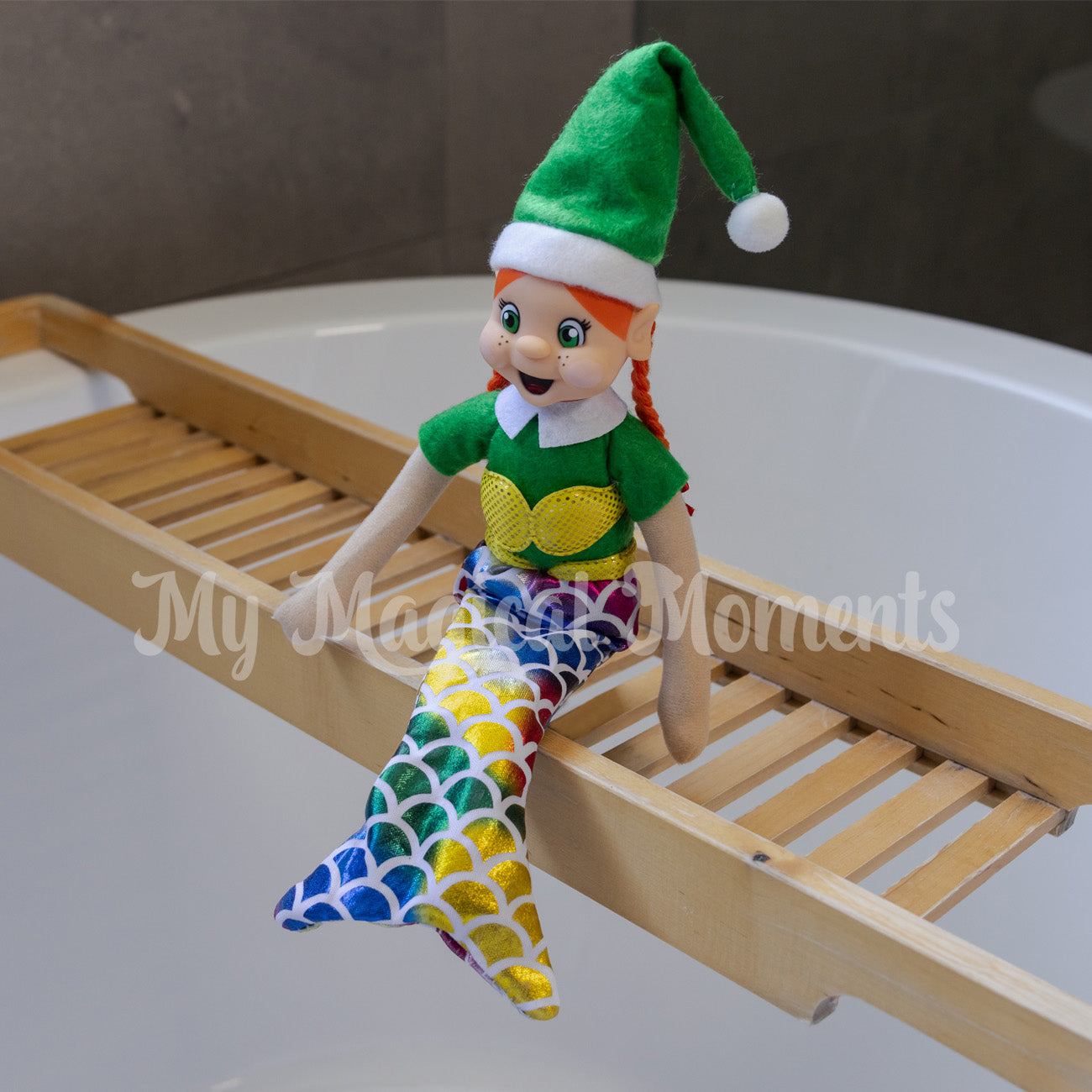 Red headed elf wearing a mermaid costume in bathtub