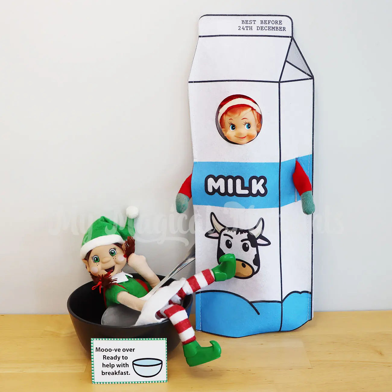 Elf wearing a milk costume with an elf in a bowl