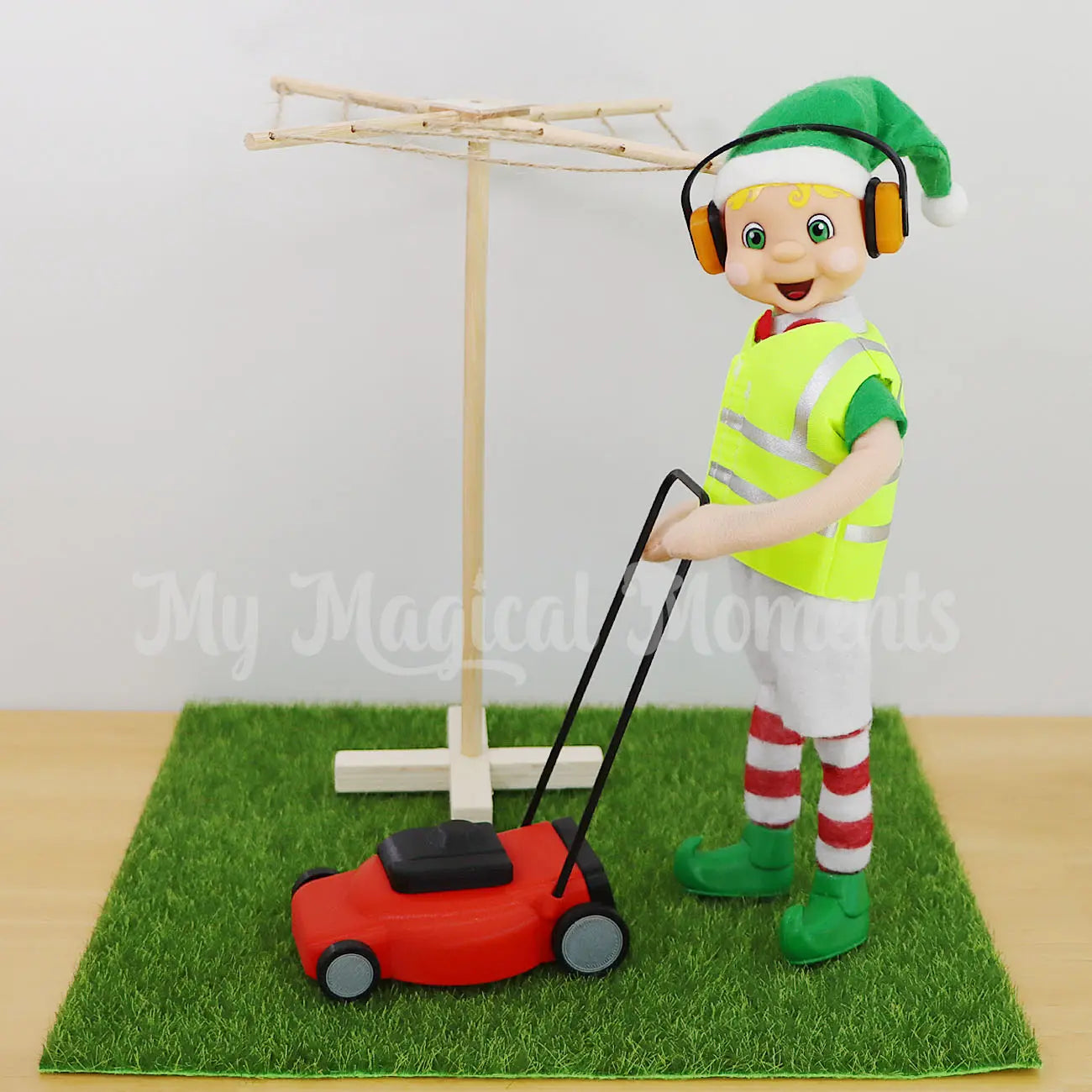 Blonde Hair My Elf Friend Elf Mowing a patch of grass with an elf sized lawn mower and a clothesline