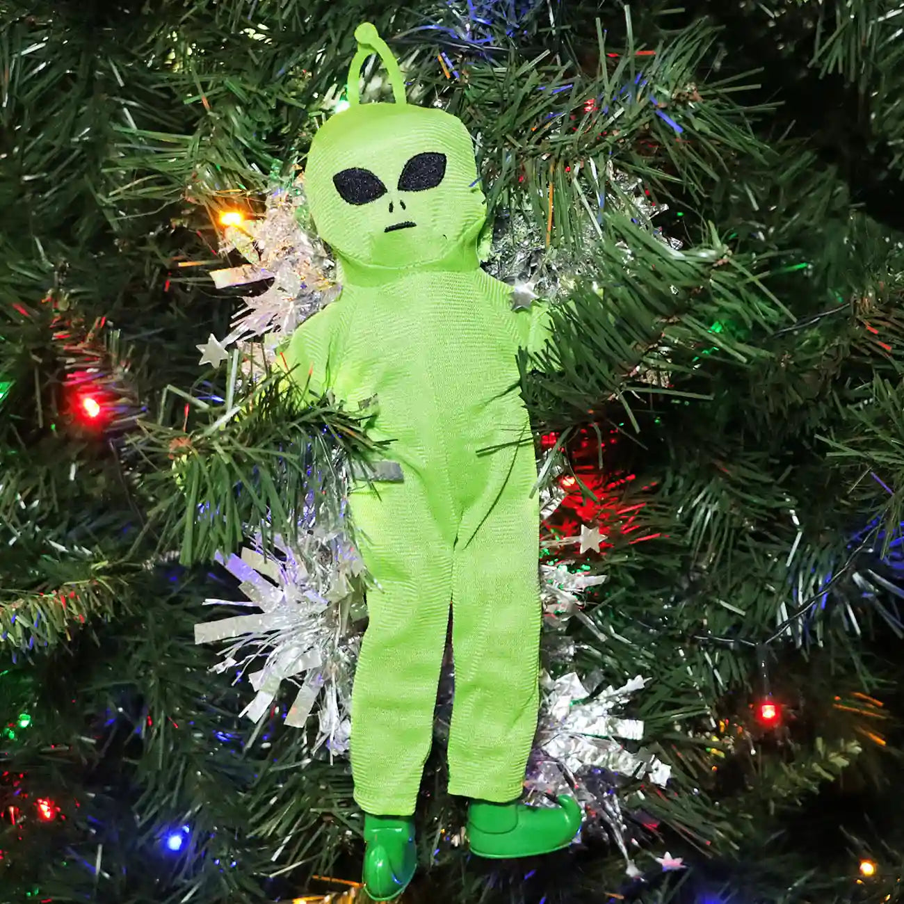 Elf wearing an alien costume in the Christmas tree