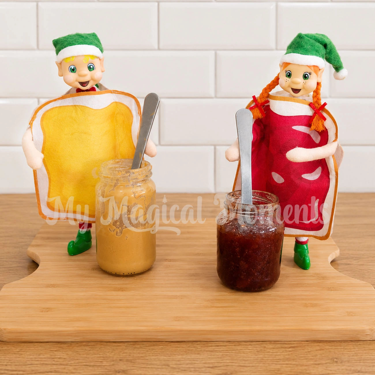 Bendable Standing My Elf Friend Elves wearing Peanut Butter & Jelly costumes standing on a chopping board in the kitchen. Playing with peanut butter and Jam spread