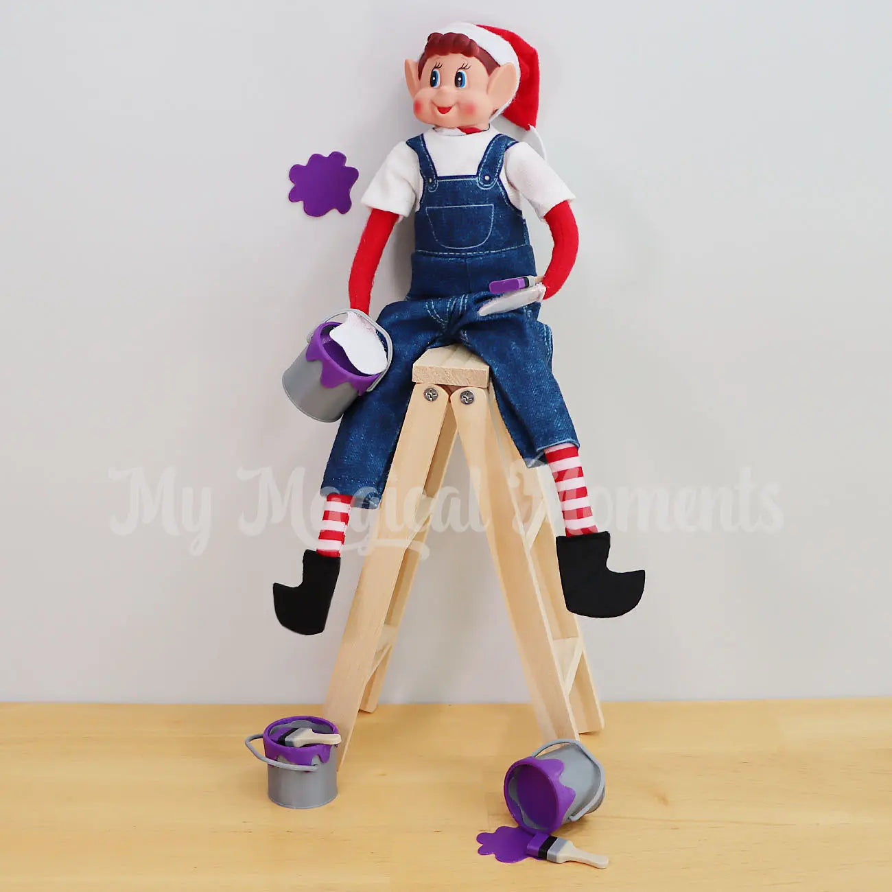 Elves Behavin Badly Elf Holding a mini paint tin painting the house