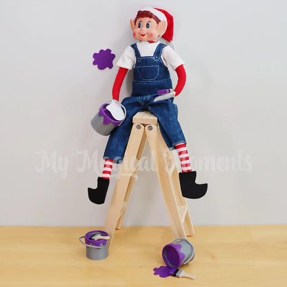 Elves Behavin Badly Elf Holding a mini paint tin painting the house