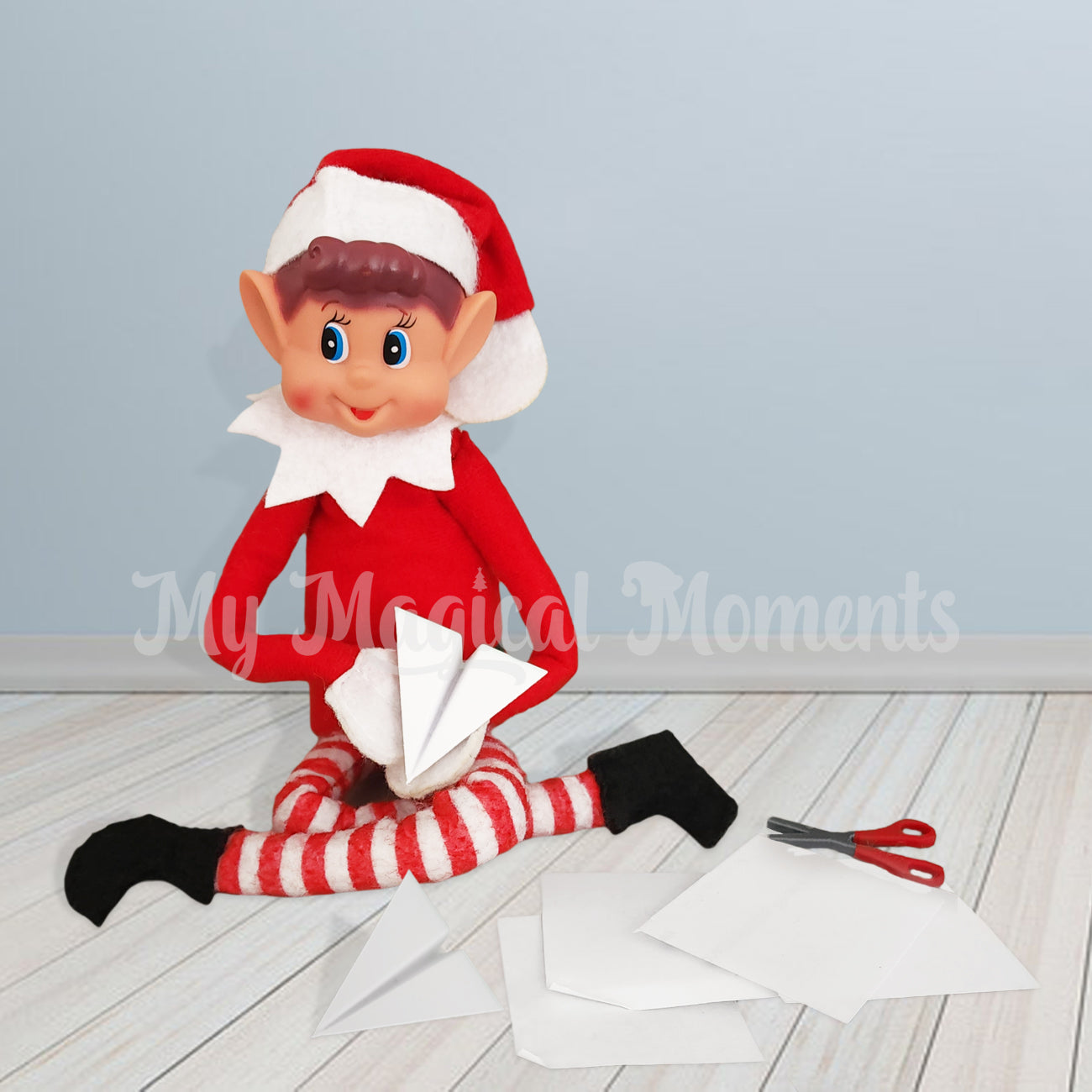 An Elves behavin badly elf using a paper airplane prop, with paper and tiny scissors By My Magical Moments