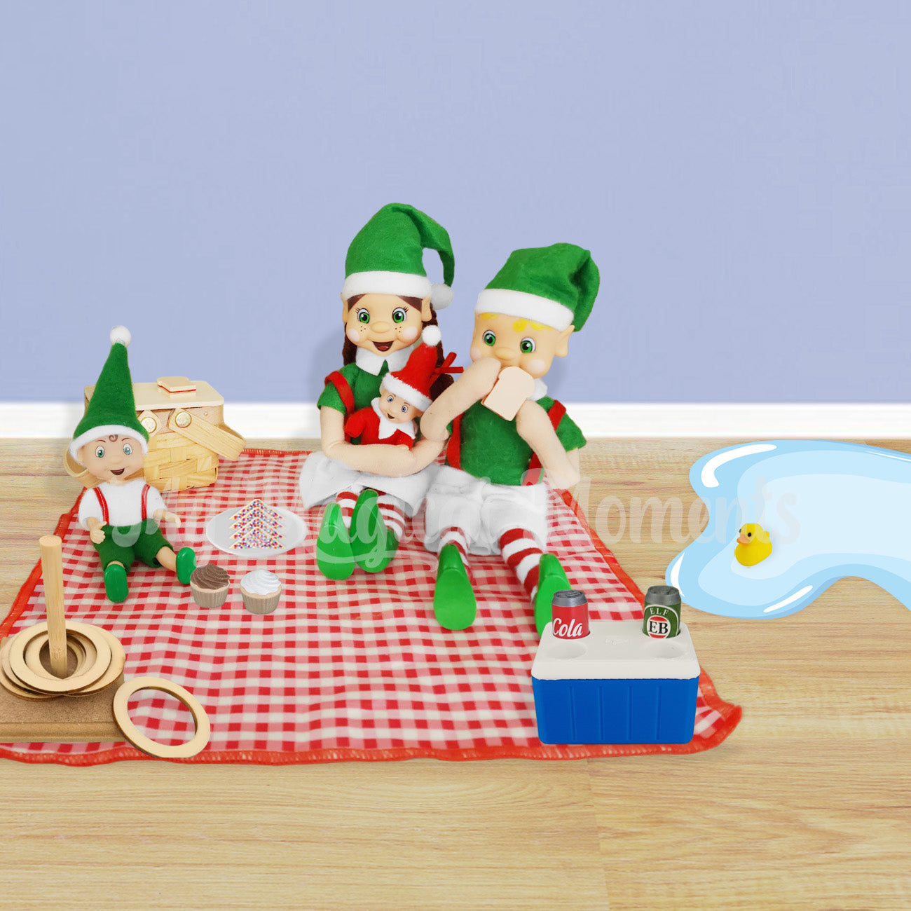 Family of elves having a picnic on a miniature picnic rug, basket, esky and mini duck
