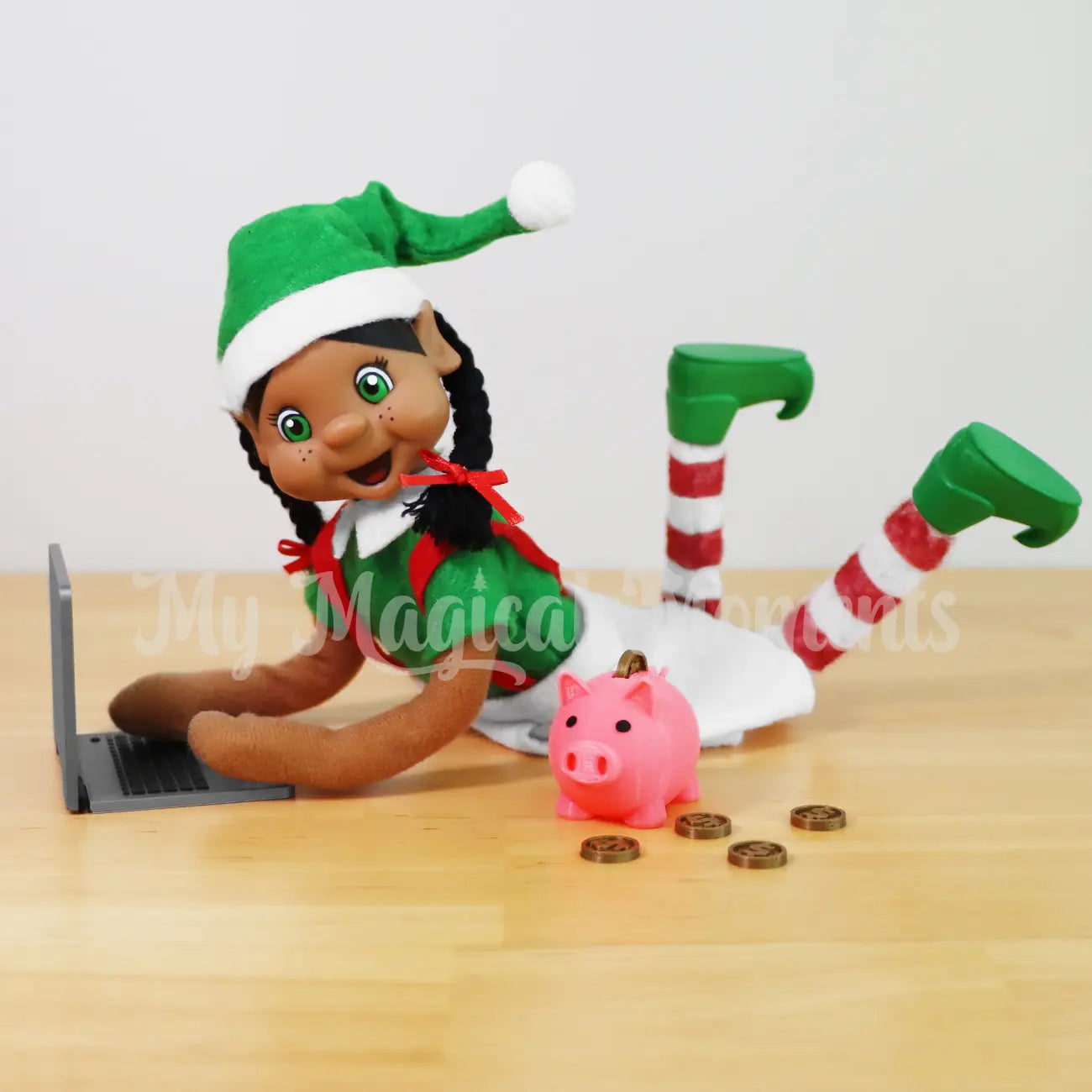 Black Hair My Elf friends Elf searching on a mini laptop with a mini piggy bank and coins