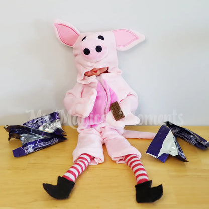 Elf wearing a pig costume pigging out on chocolate