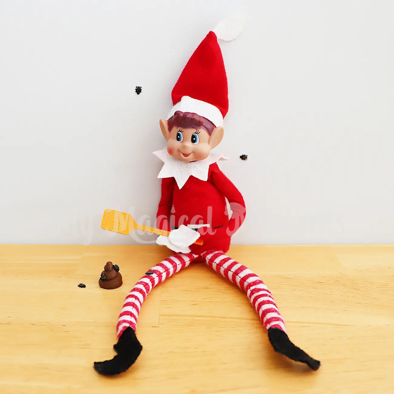 elf swatting flies off mini poo with miniature fly swatter prop and mini flies